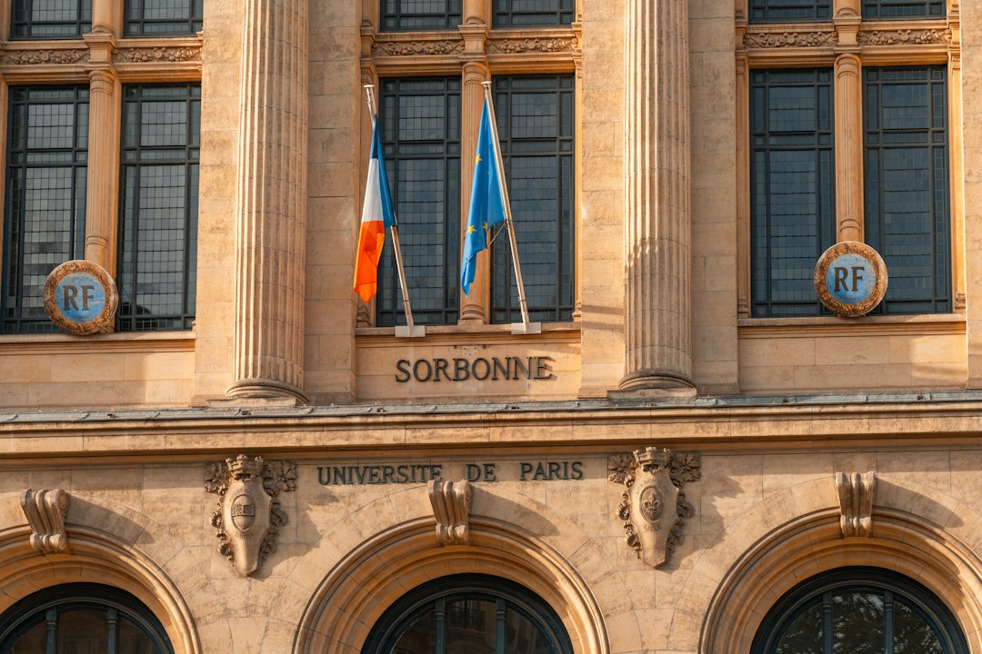 Scholarships in France for Indian students – Sorbonne University building in Paris with French flags